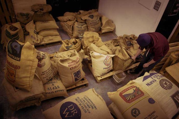 Green coffee beans arrive from all over the world in their distinctive hessian bags.